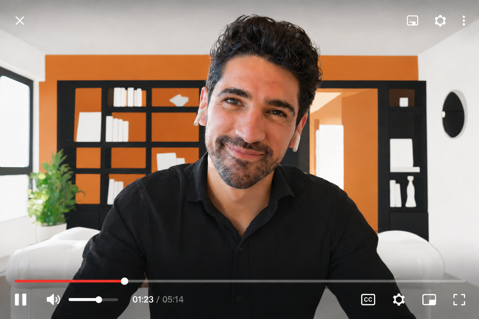 A smiling video-call participant wearing earbuds, with the recording playback controls visible.